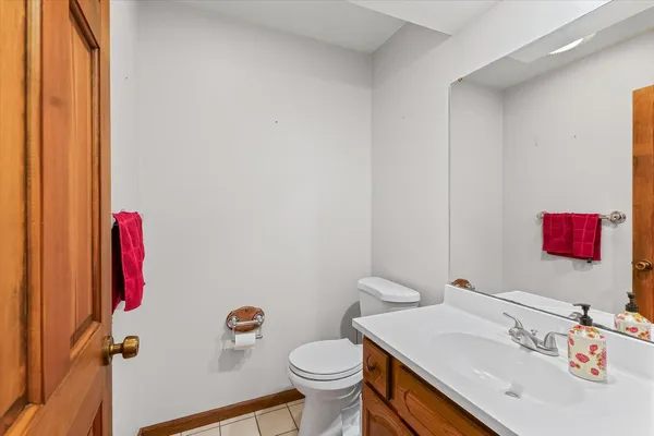 a bathroom with a sink toilet and a mirror