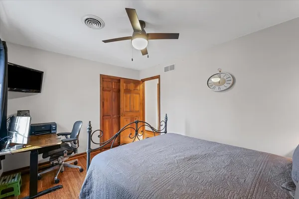 a bedroom with a bed and a desk
