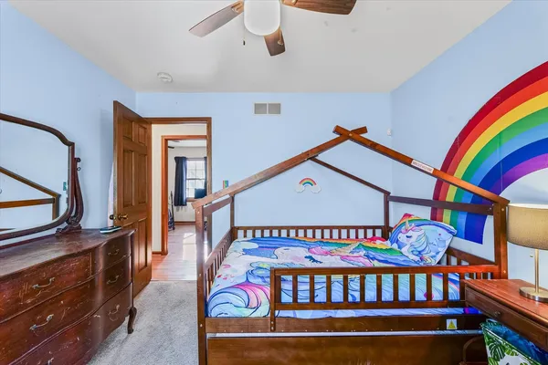 a bedroom with furniture and a baby crib