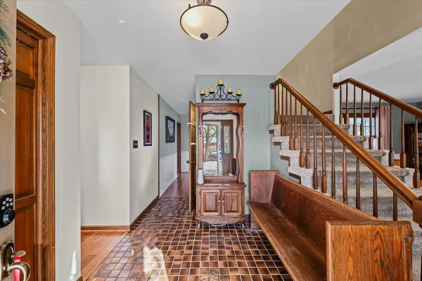 a view of a hallway with windows and stairs