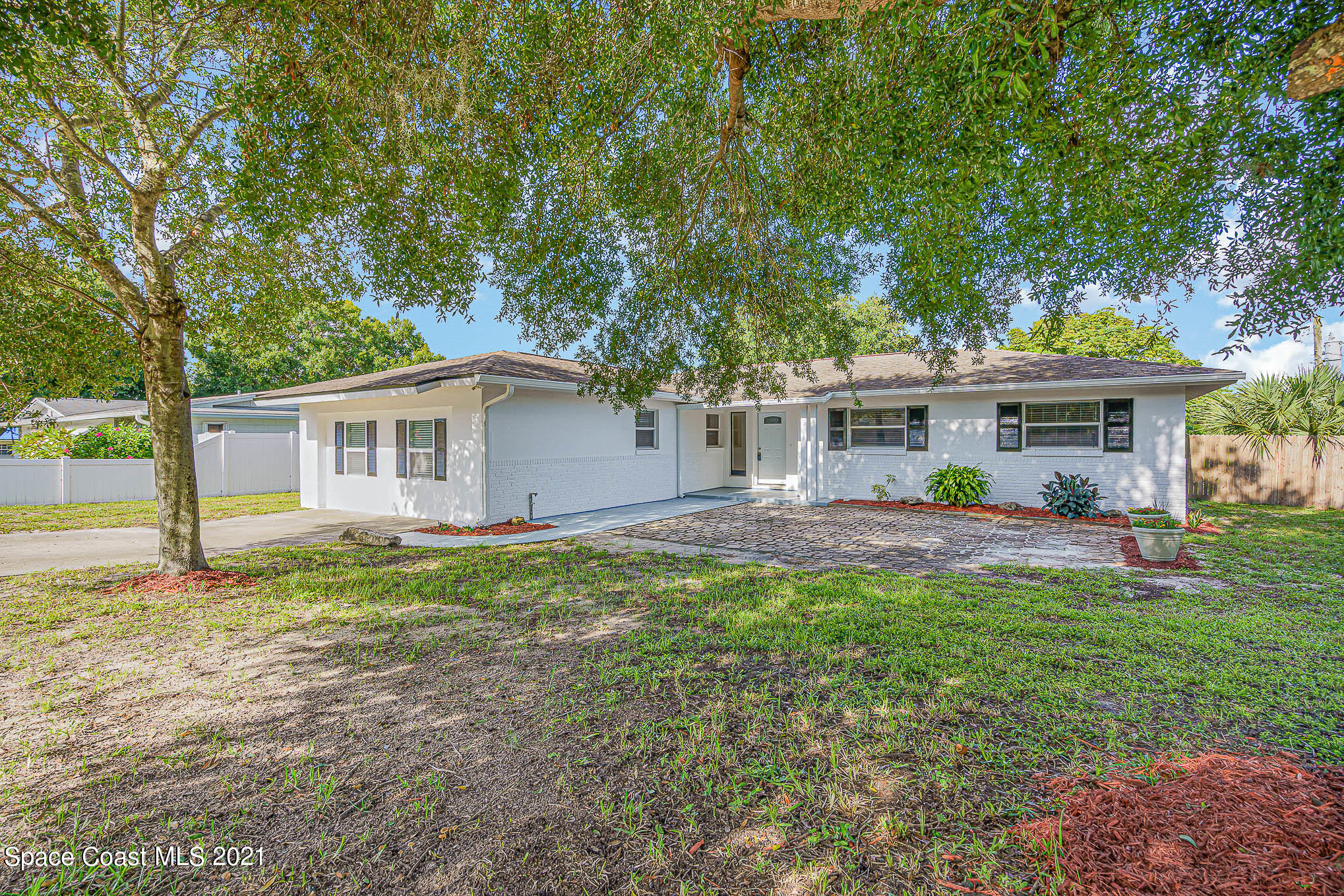 1120 North Carpenter Road Titusville, FL 32796 - Photo 1 of 22 a view of a house with a yard and sitting area