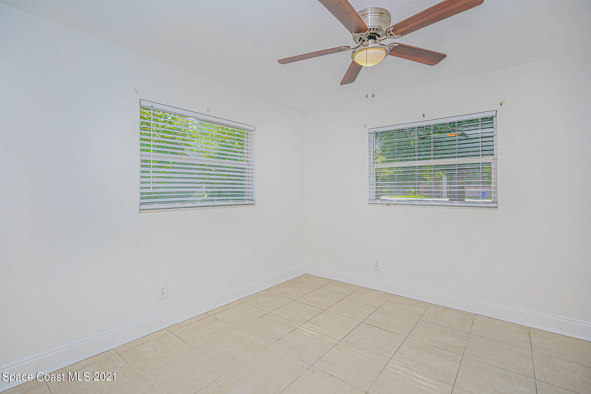 1120 North Carpenter Road Titusville, FL 32796 - Photo 12 of 22 a view of an empty room with a window