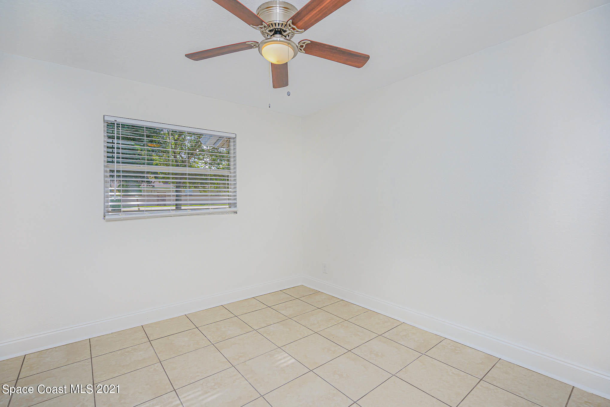 1120 North Carpenter Road Titusville, FL 32796 - Photo 13 of 22 an empty room with a window