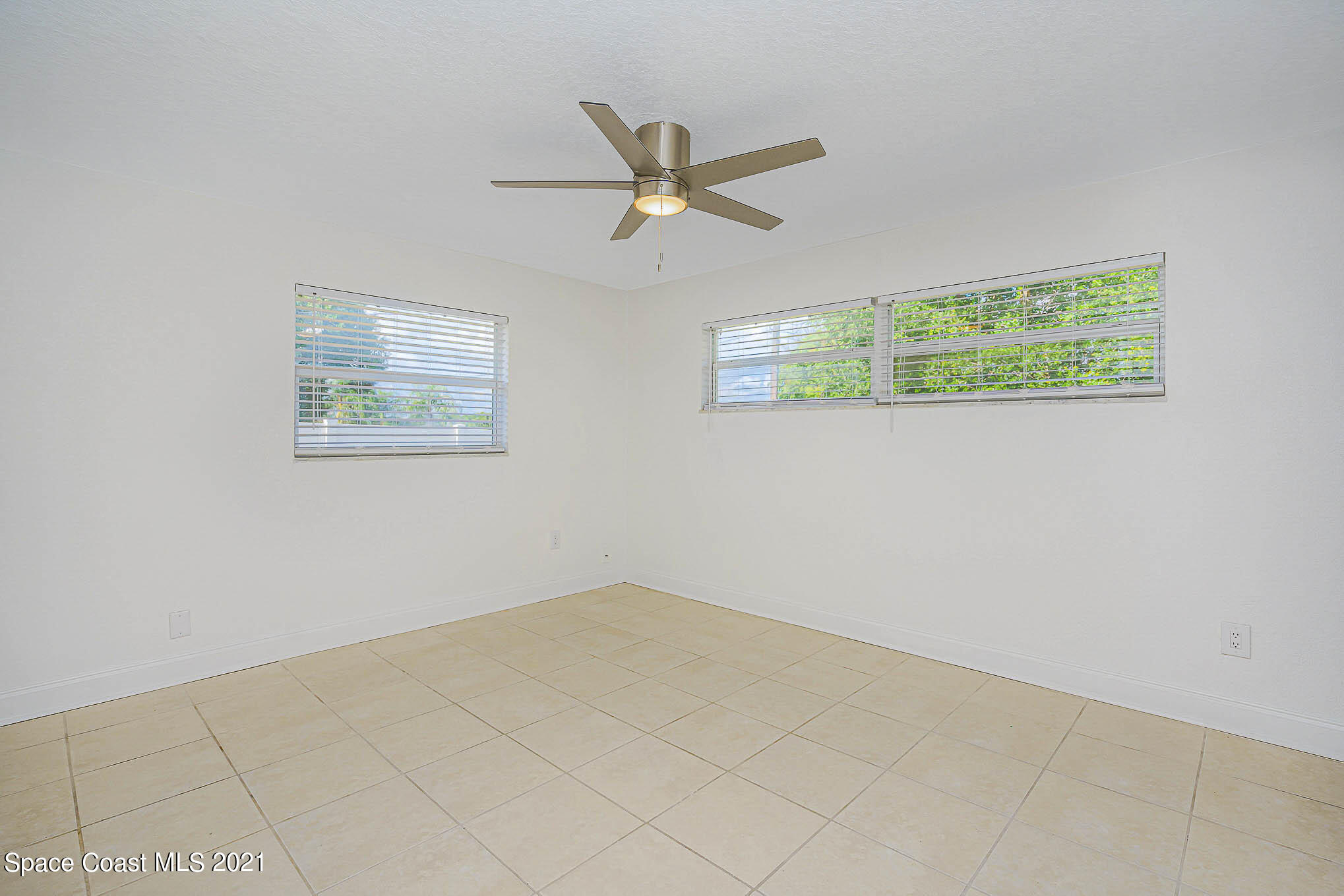 1120 North Carpenter Road Titusville, FL 32796 - Photo 14 of 22 a view of a big room with wooden floor and windows