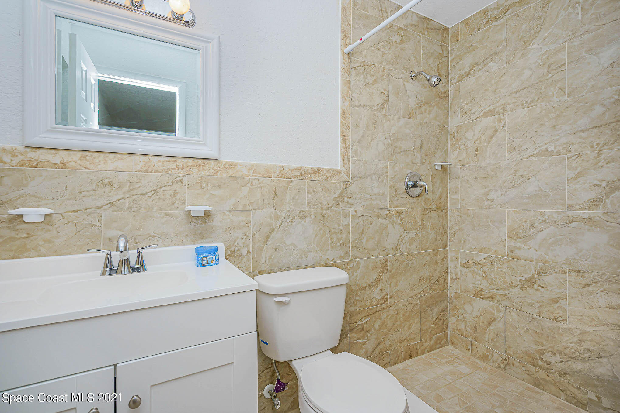 1120 North Carpenter Road Titusville, FL 32796 - Photo 16 of 22 a bathroom with a toilet sink and mirror
