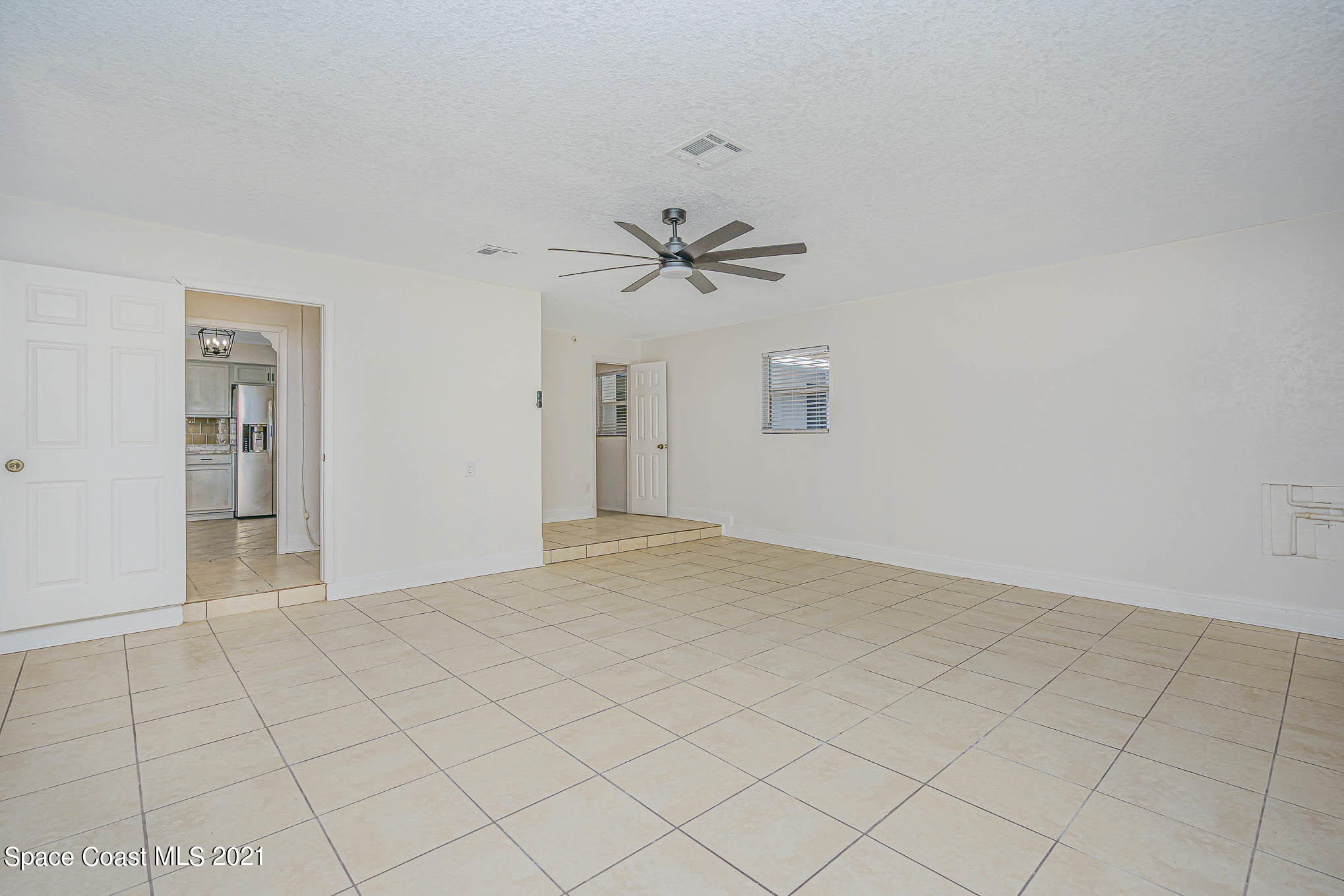 1120 North Carpenter Road Titusville, FL 32796 - Photo 18 of 22 a view of an empty room with a window