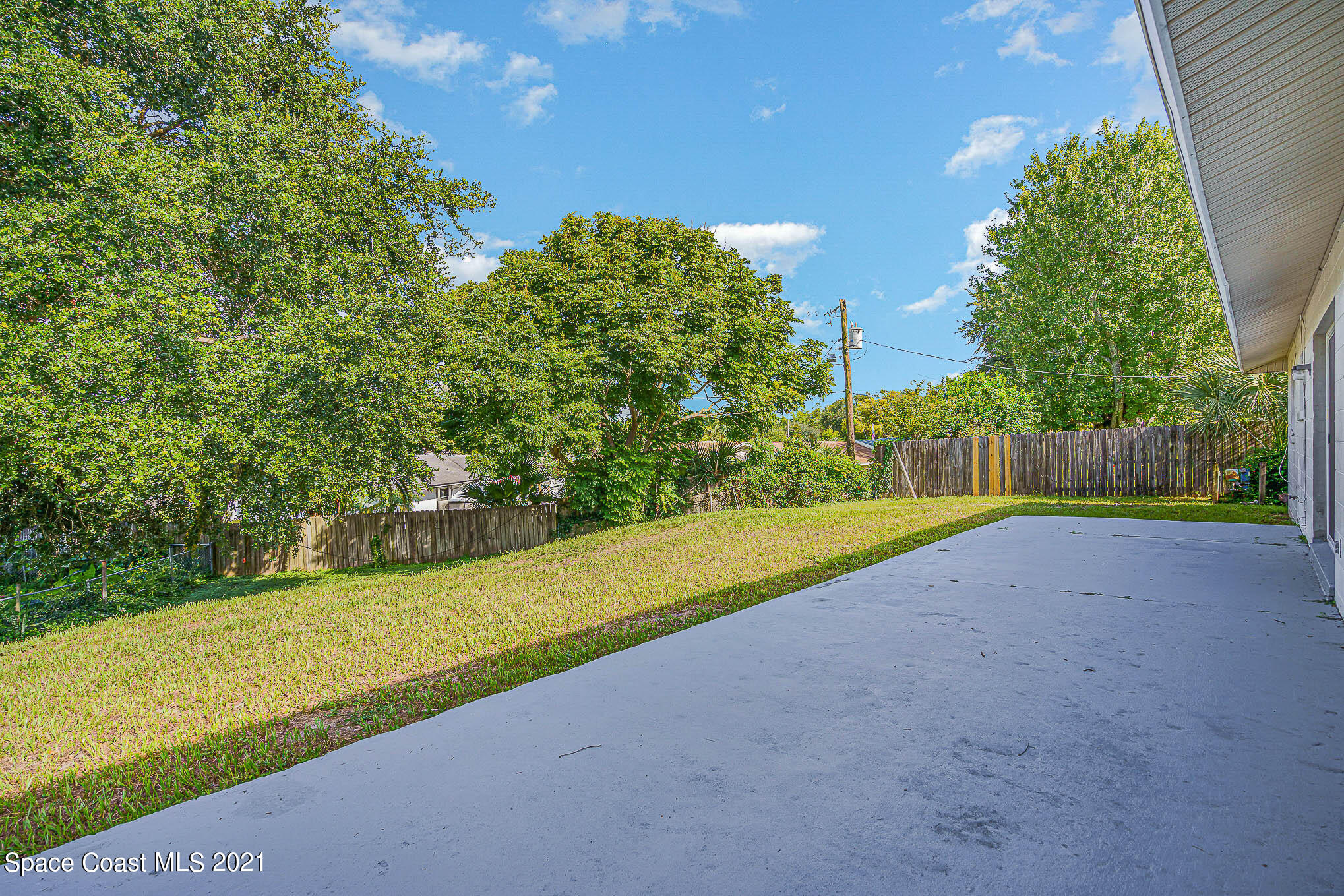 1120 North Carpenter Road Titusville, FL 32796 - Photo 21 of 22 a view of a field with large trees