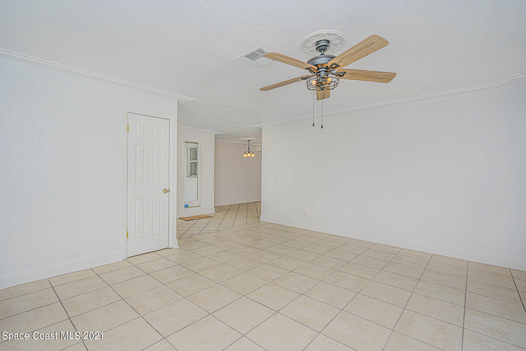 1120 North Carpenter Road Titusville, FL 32796 - Photo 5 of 22 a view of a livingroom with a ceiling fan and window