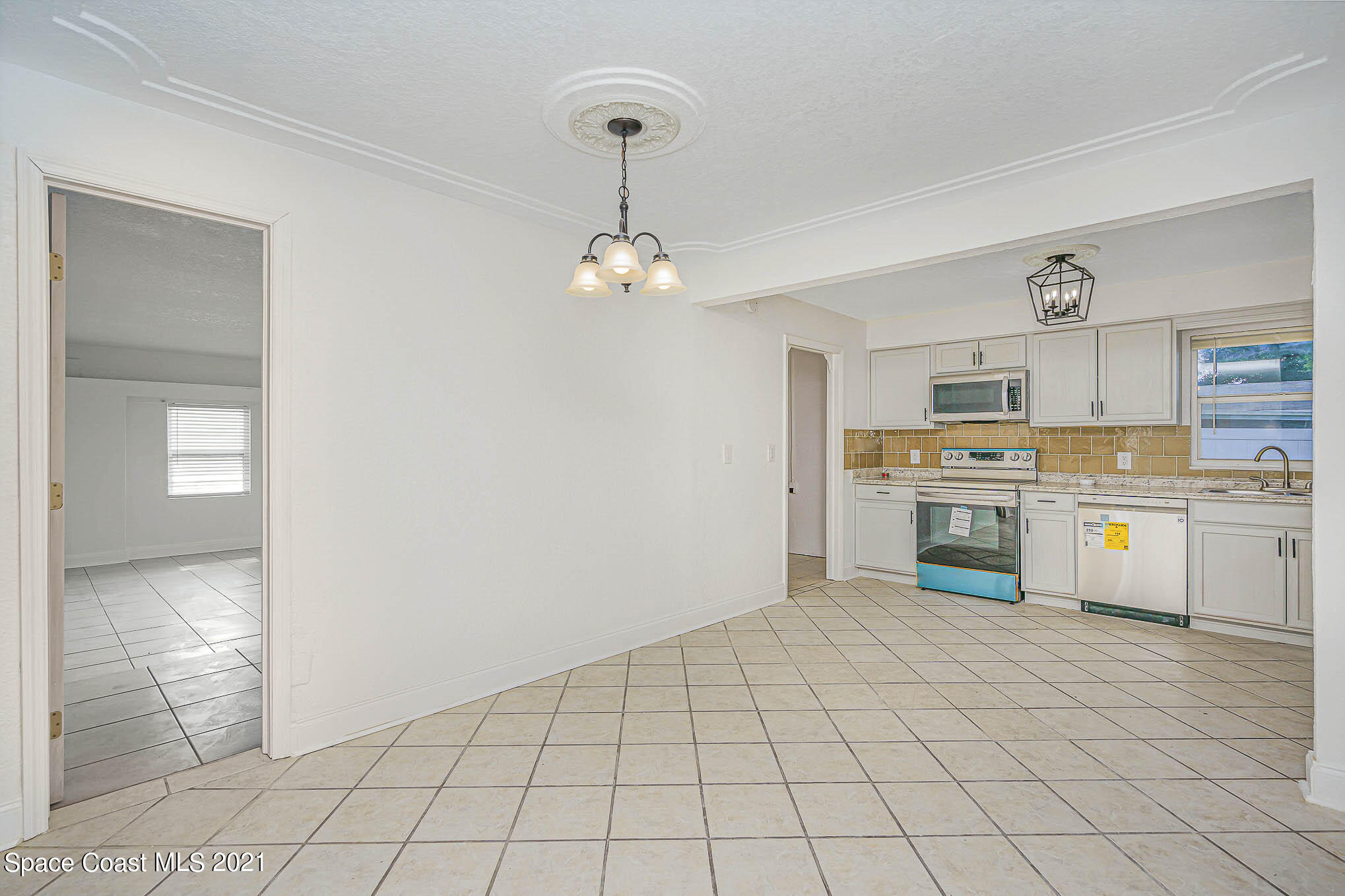 1120 North Carpenter Road Titusville, FL 32796 - Photo 6 of 22 a view of kitchen with granite countertop cabinets and window