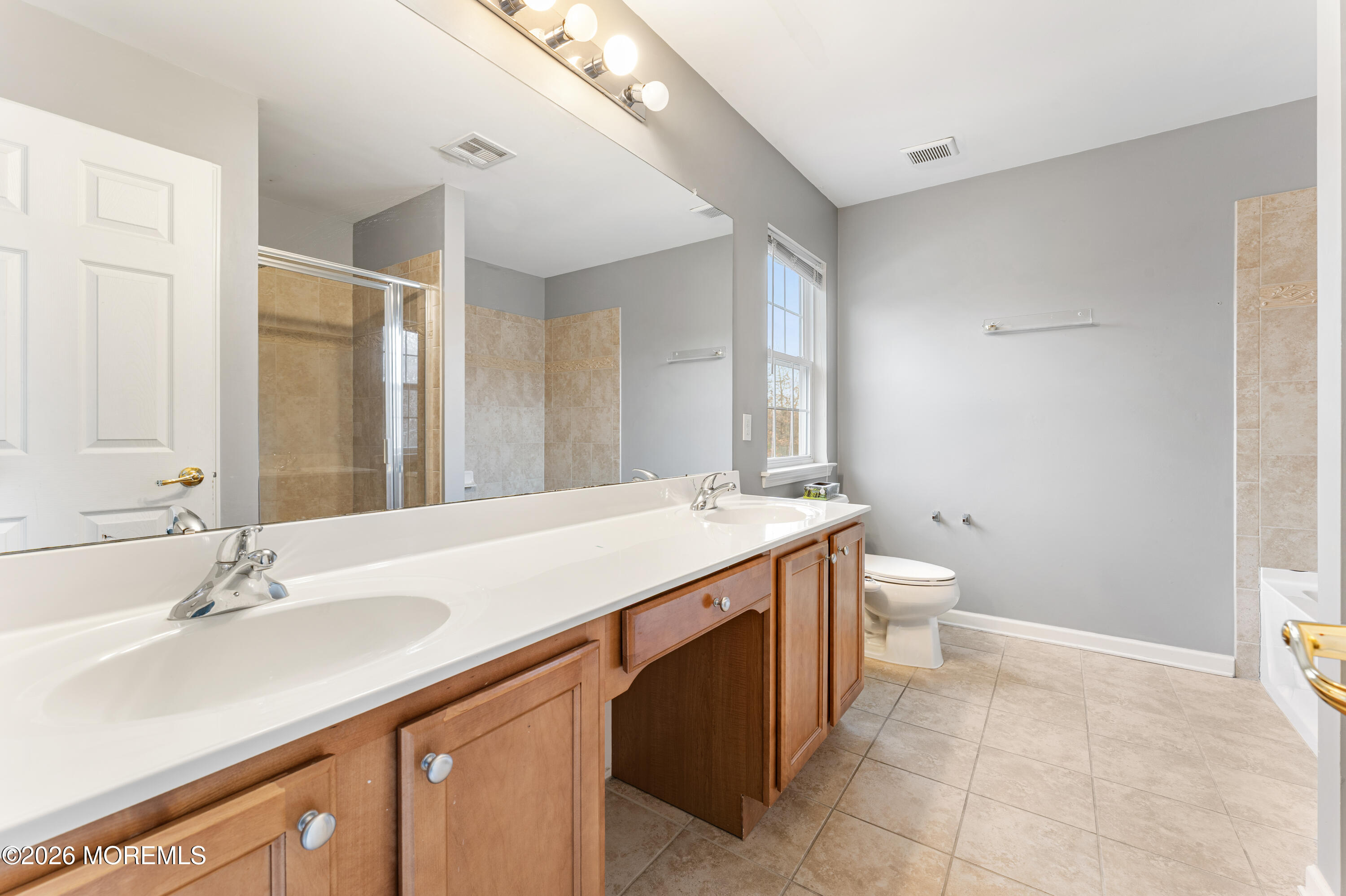 44 Imperial Place North Jackson, NJ 08527 - Photo 22 of 38 a bathroom with a sink a toilet and a large mirror