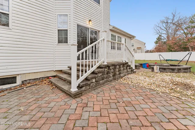 a view of a house with a small yard and wooden floor and fence