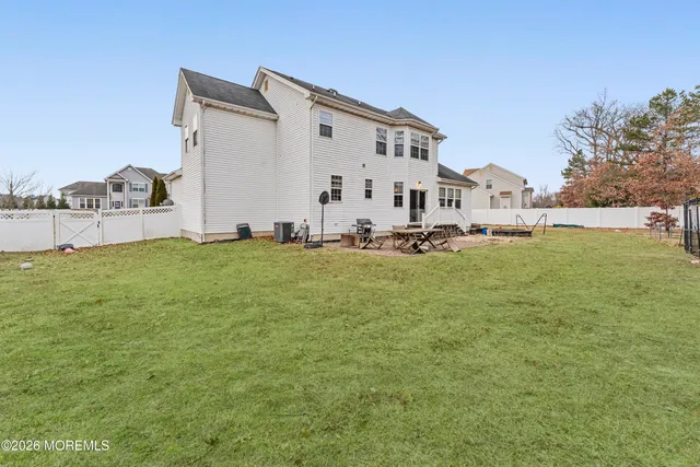 a view of a house with a big yard and large trees
