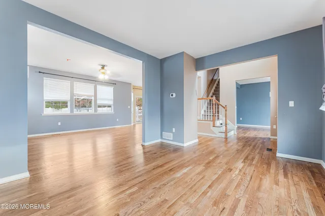 a view of a room with wooden floor and a window