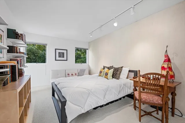 a bedroom with a bed a couch and dresser