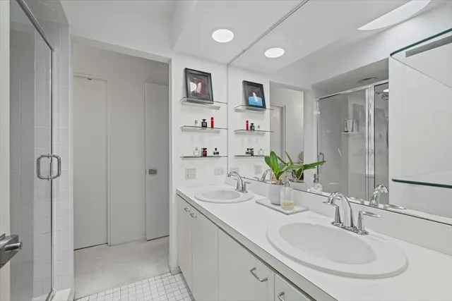 a bathroom with a double vanity sink mirror and