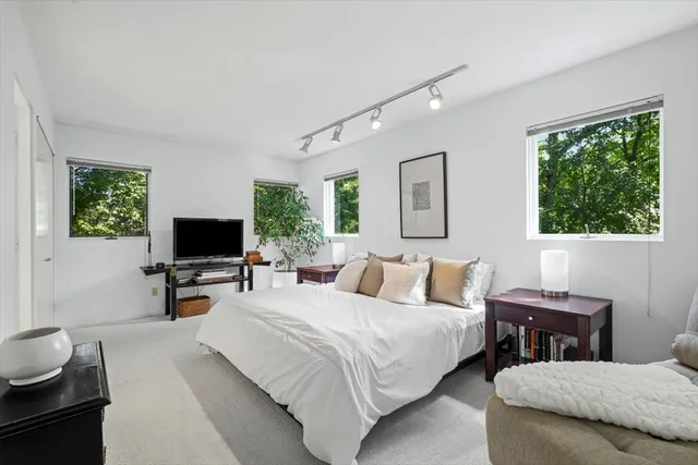 a bedroom with two beds and a flat screen tv