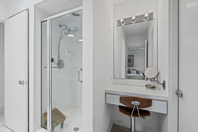 a bathroom with a shower sink and mirror