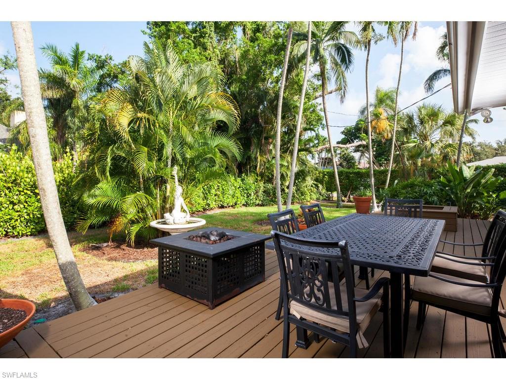 641 Palm Circle West Naples, FL 34102 - Photo 11 of 13 a view of a backyard with table and chairs with wooden floor