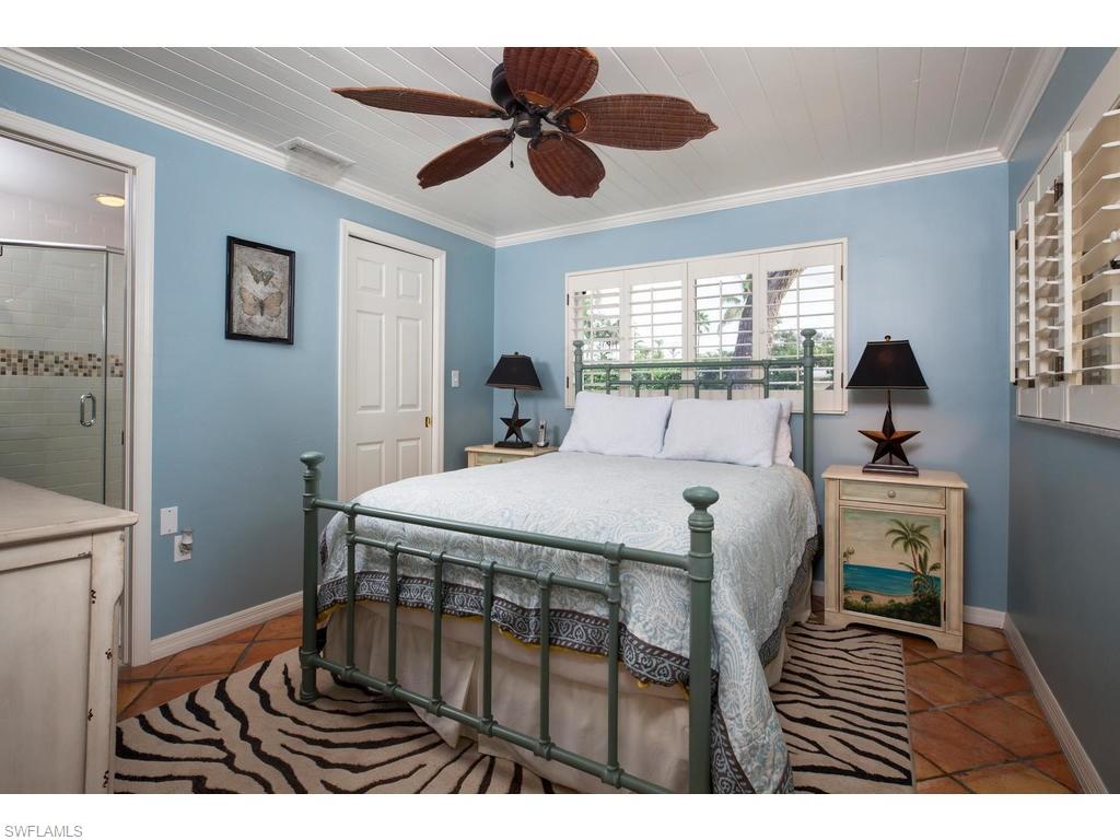 641 Palm Circle West Naples, FL 34102 - Photo 7 of 13 a bedroom with a bed and a window