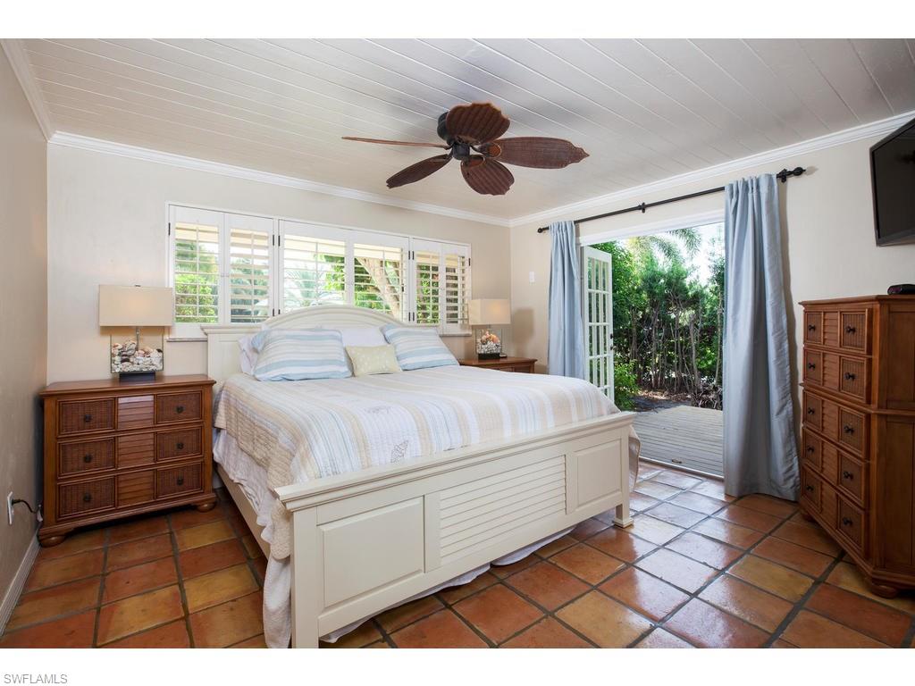 641 Palm Circle West Naples, FL 34102 - Photo 8 of 13 a spacious bedroom with a bed and a dresser