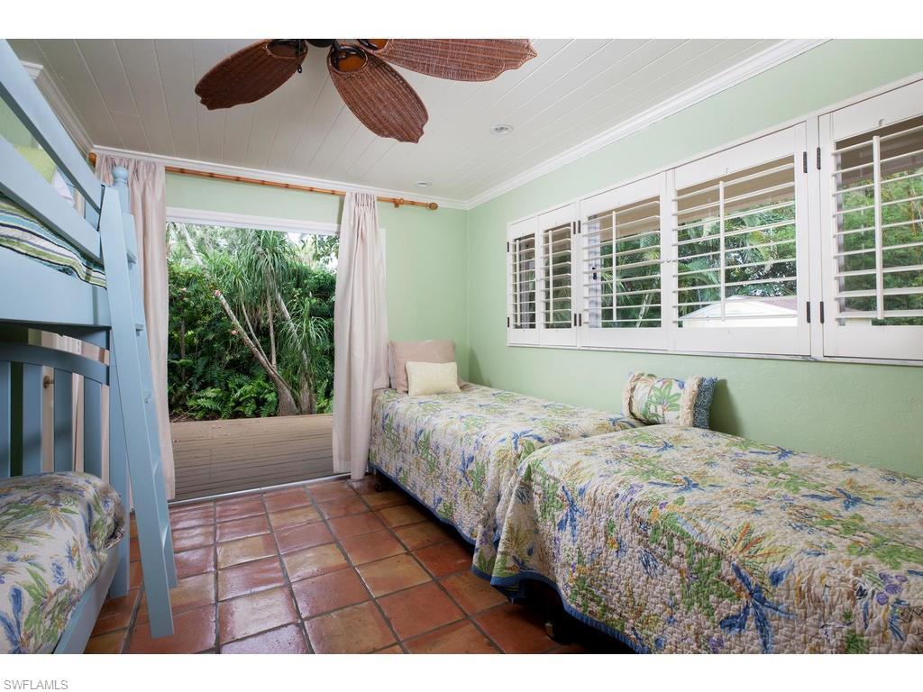 641 Palm Circle West Naples, FL 34102 - Photo 10 of 13 a bedroom with a bed dresser and a window