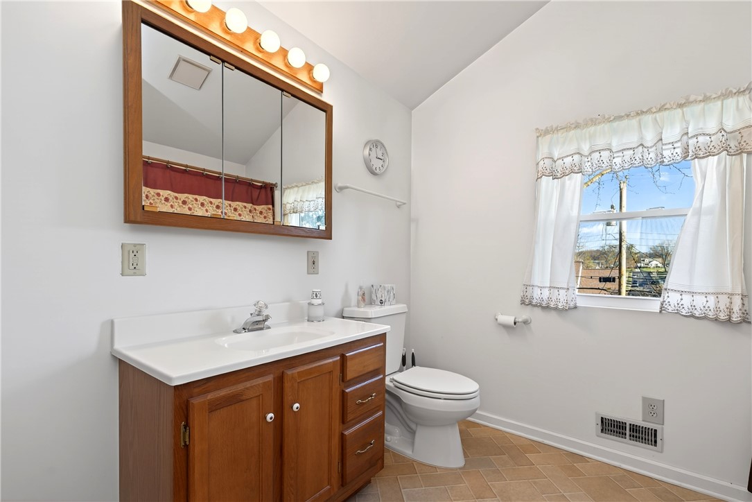 1237 Laurelwood Road Dayton, OH 45409 - Photo 30 of 56 This bright bathroom features a vanity with ample storage, a window, and durable tile flooring.