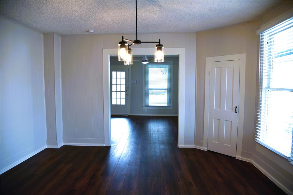 900 West Chestnut Street Denison, TX 75020 - Photo 8 of 22 an empty room with wooden floor and windows