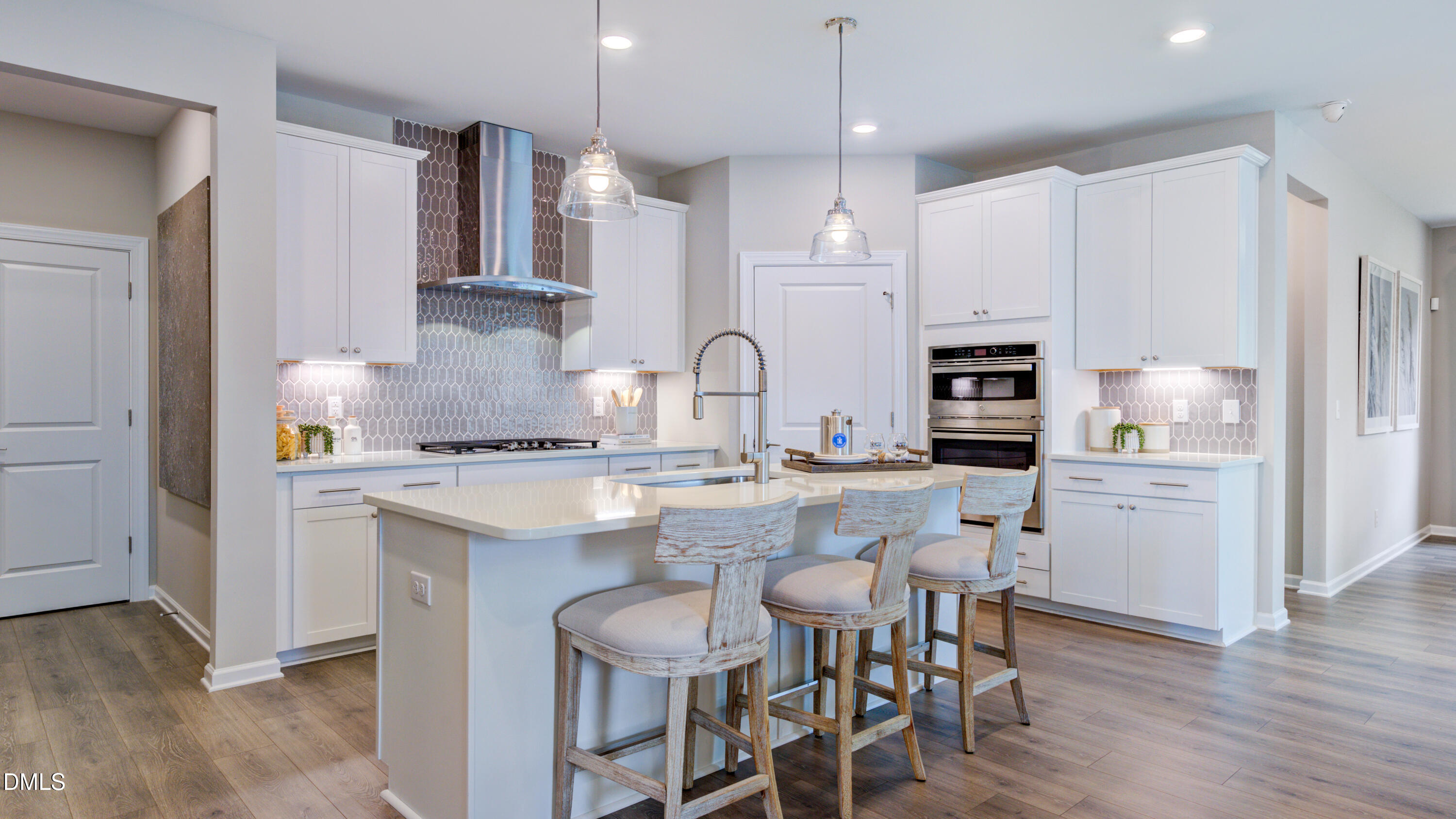 2000 Clydner Drive Apex, NC 27523 - Photo 16 of 36 a kitchen with white cabinets and stainless steel appliances