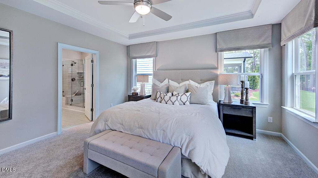 2000 Clydner Drive Apex, NC 27523 - Photo 18 of 36 a bedroom with a bed and a chandelier