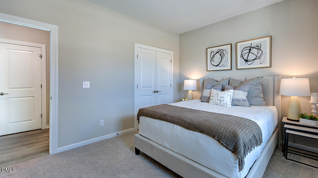 2000 Clydner Drive Apex, NC 27523 - Photo 21 of 36 a bedroom with bed and painting on the wall