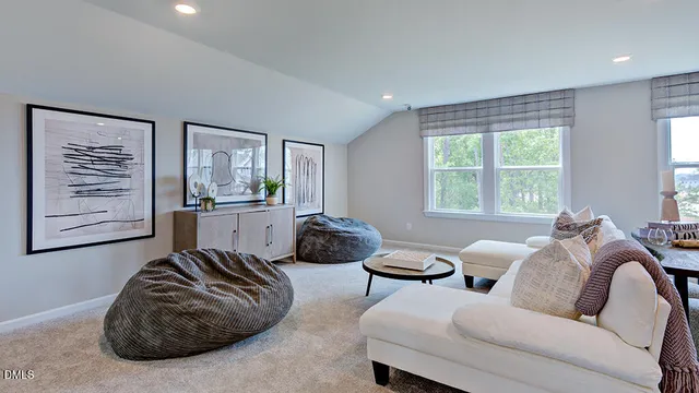 a bedroom with a bed and a lamp on dresser