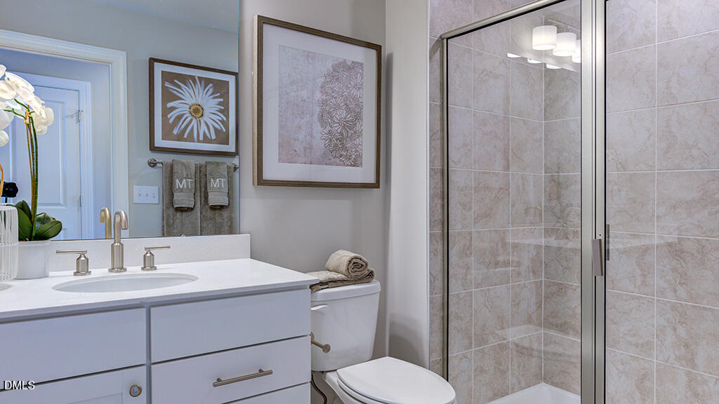 2000 Clydner Drive Apex, NC 27523 - Photo 27 of 36 a bathroom with a toilet sink and mirror