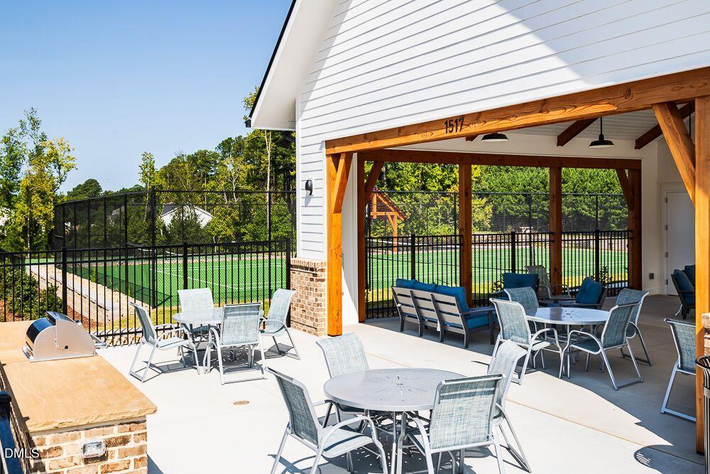 2000 Clydner Drive Apex, NC 27523 - Photo 36 of 36 a view of a patio with a table chairs and a backyard