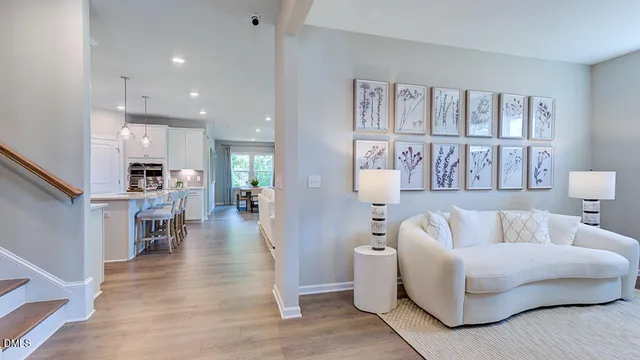 a living room with furniture a bookshelf and a window