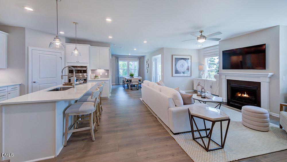 2000 Clydner Drive Apex, NC 27523 - Photo 8 of 36 a living room with furniture fireplace and flat screen tv