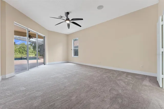 a view of a big room with wooden floor and windows in a room