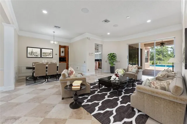 a living room with furniture potted plant and a large window