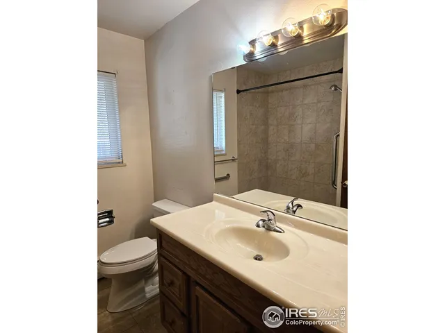 a bathroom with a sink toilet and mirror