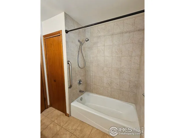 a bathroom with a shower and a bath tub