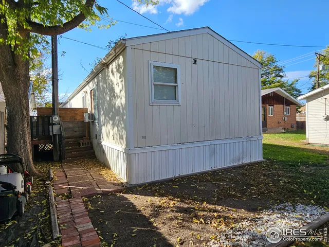 a yellow house with trees in front of it