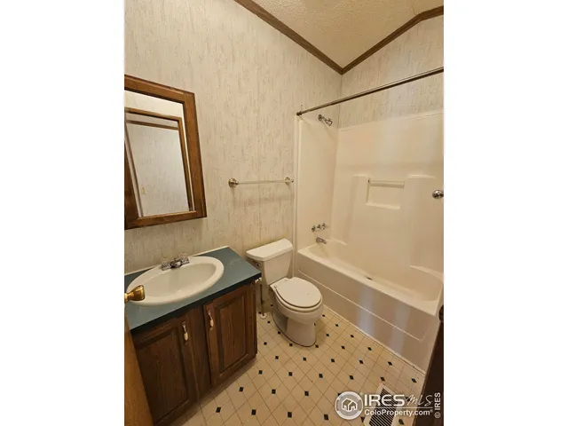 an empty room with windows and cabinet