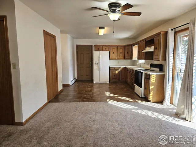 a view of a kitchen with a sink and a window