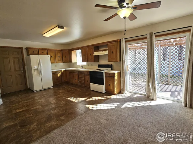 a view of a kitchen with fridge and a sink