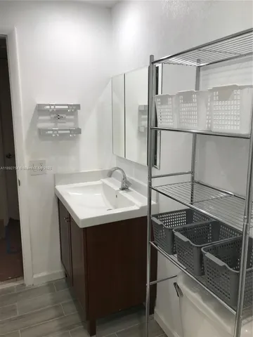 a bathroom with a sink and mirror