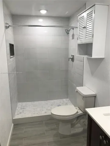a bathroom with a toilet a sink and a shower