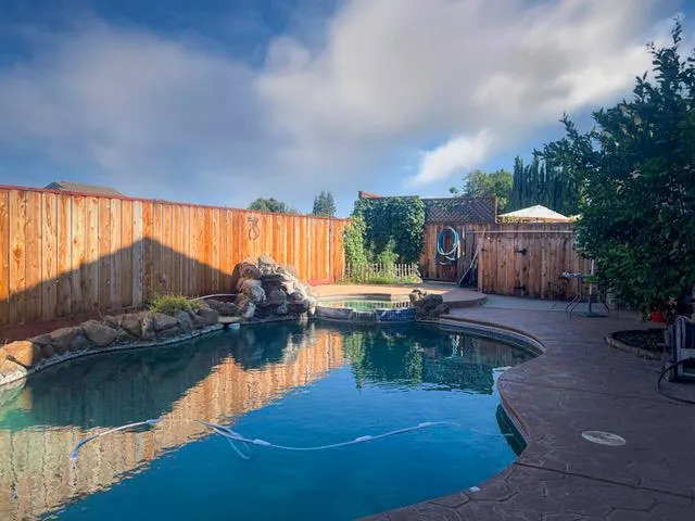 a swimming pool with outdoor seating and yard