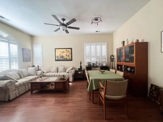 a living room with furniture a large window and a table