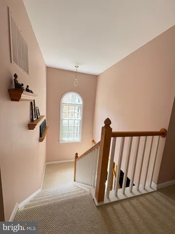 a view of a livingroom with a flesh screen tv and stairs
