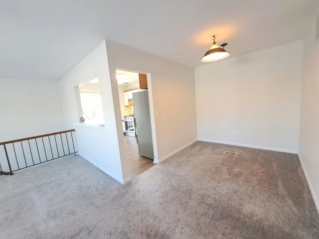 a view of an empty room with a fan