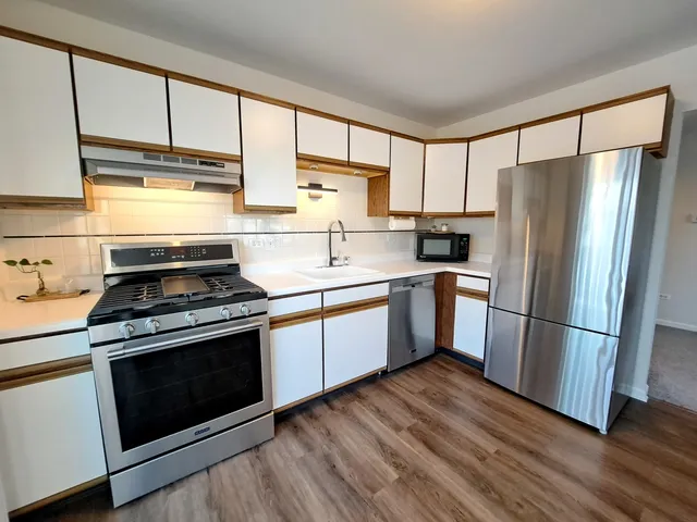 a kitchen with a stove a sink and a refrigerator